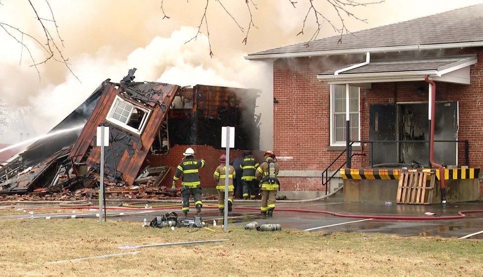 Partial structural collapse of an engineering support structure following sustained fire involvement.