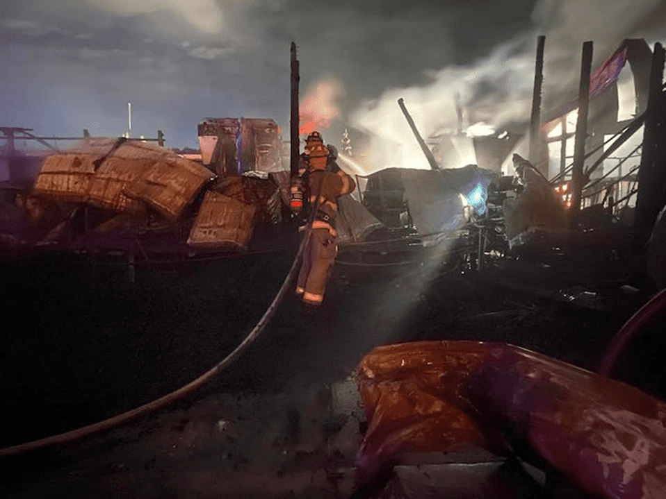Debris covers the ground after the fire where the greenhouse once stood.