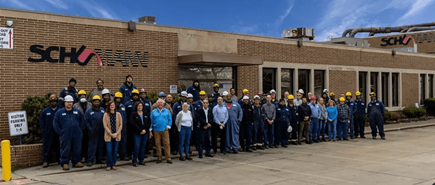 Image: I. Schumann & Co. gather outside the building for a group photo (2022),