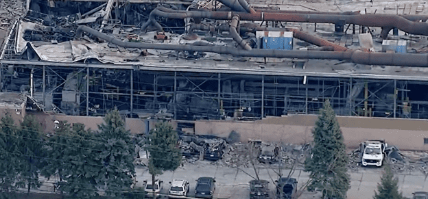 Image: Metal factory explosion and fire destroy the building, leaving only the frame and ductwork. 